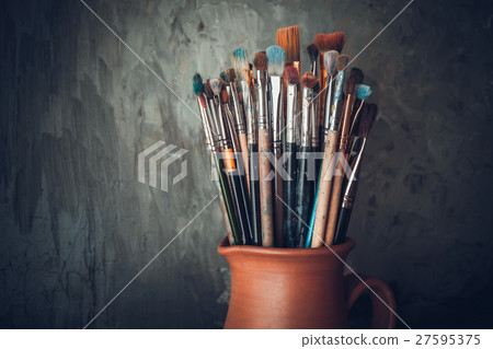 Paintbrushes in a jug from potters clay. 27595375