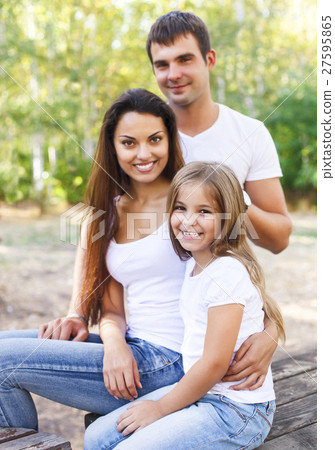 Happy mother father and their daughter in the park 27595865