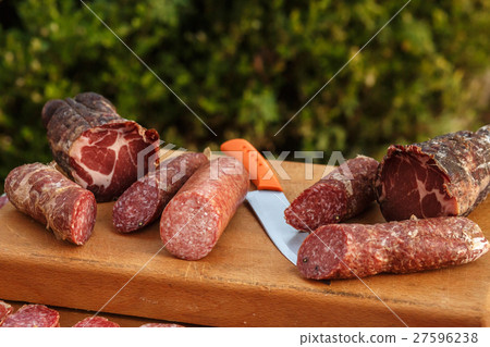 Salted italian meat lies on wooden board  Salted italian meat lies on wooden board  27596238