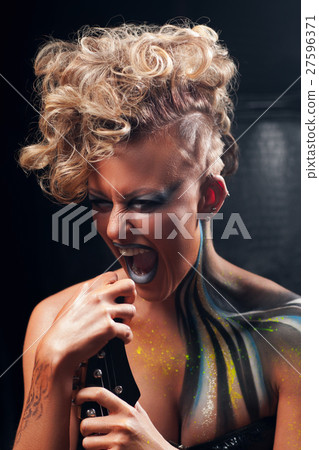 Portrait of screaming punk woman with body art Portrait of screaming punk woman with body art 27596371