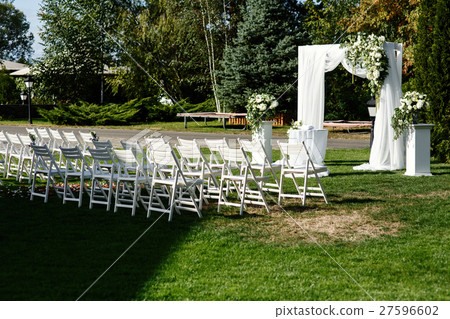 White garden chairs stand in rows before wedding  27596602