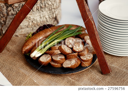 Black plate with sausages and green Black plate with sausages and green 27596756