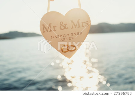 Sun shines over white wooden heart Sun shines over white wooden heart 27596793