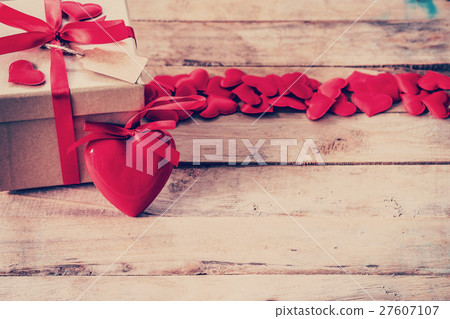 Gift box and red heart on wood table with space 27607107