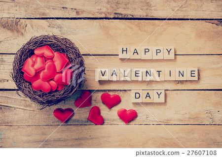 Red heart in nest with wooden text Happy Valentine 27607108