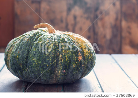 Pumpkin on wooden table. 27608869
