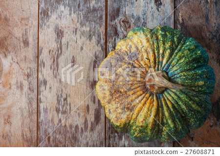Pumpkin with the soil on wooden. 27608871