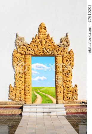 Old door with wooden facade and road in meadow Old door with wooden facade and road in meadow 27610202