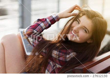 Face portrait of young woman using a tablet pc Face portrait of young woman using a tablet pc 27612130