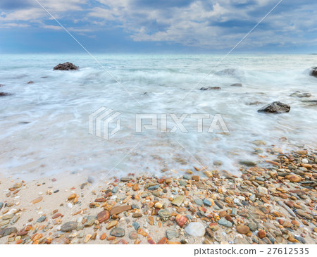 Long exposure shot. Sea scape with stone beach Long exposure shot. Sea scape with stone beach 27612535