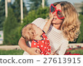 Happy mother and daughter playing in park. 27613915