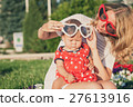 Happy mother and daughter playing in park. 27613916