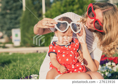 Happy mother and daughter playing in park. 27613916