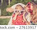 Happy mother and daughter playing in park. 27613917