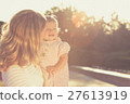 Happy mother and daughter playing in park. 27613919