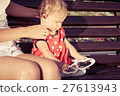 Happy mother and daughter playing in park. 27613943