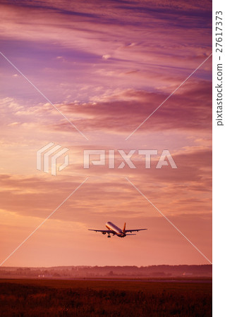 Airplane taking off at the sunset sky 27617373