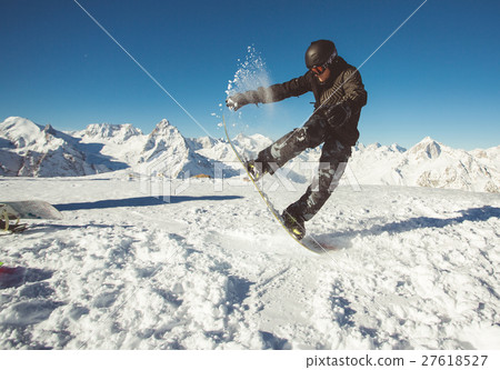 Young man jumping on snowboard. 27618527