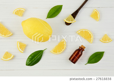 Fresh lemons and lemons leaves with essential oil  27618838
