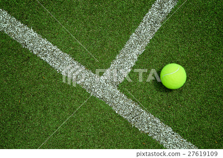 tennis ball near the line on tennis grass court go 27619109