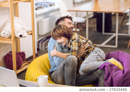 Father and his son having fun indoors 27620489