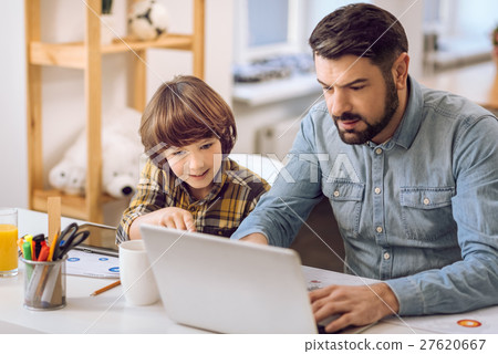Father and son playing games together 27620667