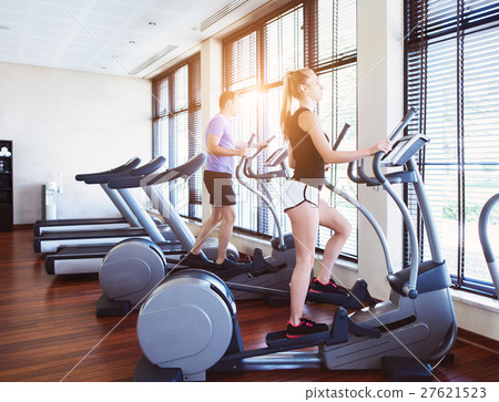Healthy couple training on a treadmill Healthy couple training on a treadmill 27621523