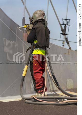 Man with helmet working on a bridge construction Man with helmet working on a bridge construction 27622033