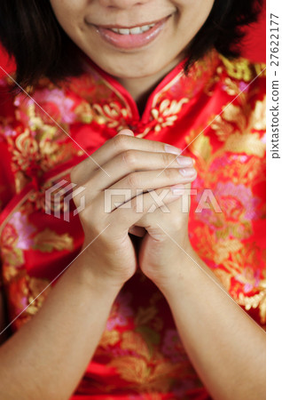 Asian woman in cheongsam with greeting gesture 27622177
