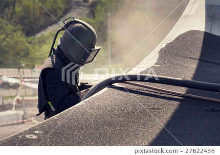 Man with helmet working on a bridge construction Man with helmet working on a bridge construction 27622436