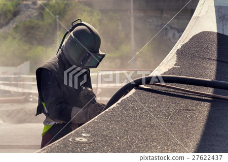 Man with helmet working on a bridge construction Man with helmet working on a bridge construction 27622437