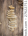 Closeup view of mushrooms stuck onto the side of a 27622751