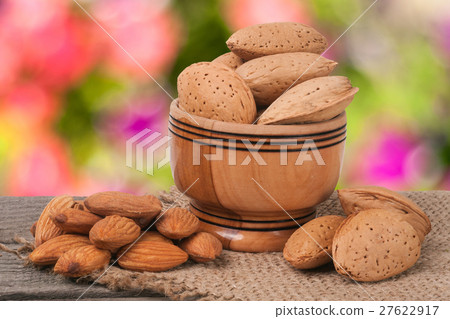 almonds in a bowl on the old wooden board blurred almonds in a bowl on the old wooden board blurred 27622917