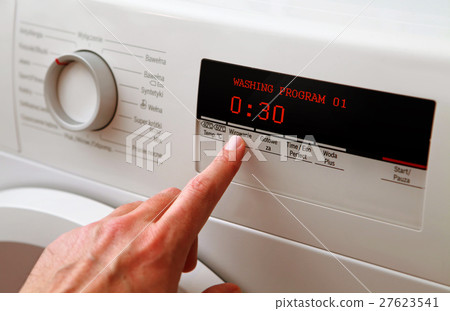 man hand adjusting washing machine man hand adjusting washing machine 27623541