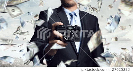 Businessman taking photo with vintage camera Businessman taking photo with vintage camera 27625223