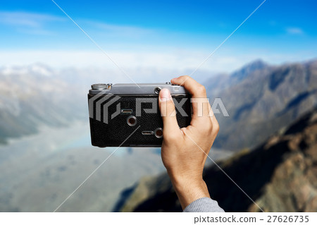 Man taking photo with vintage camera Man taking photo with vintage camera 27626735