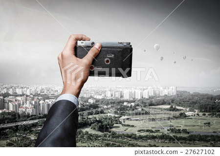 Man taking photo with vintage camera 27627102