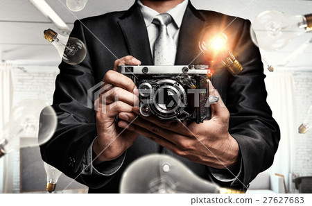 Businessman taking photo with vintage camera 27627683