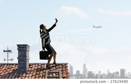 Businesswoman catching moment on her mobile 27629490