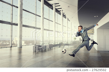 Playing football in office 27629502