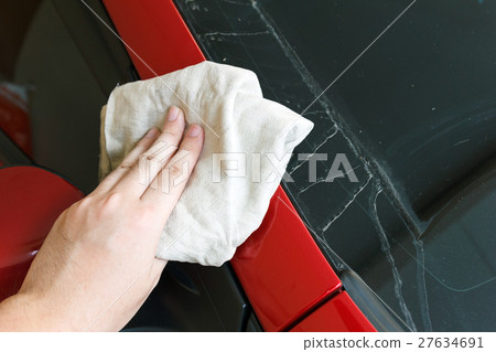 Hand cleaning car with towel. 27634691
