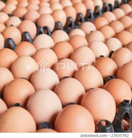 Many brown eggs in boxes. Many brown eggs in boxes. 27635762