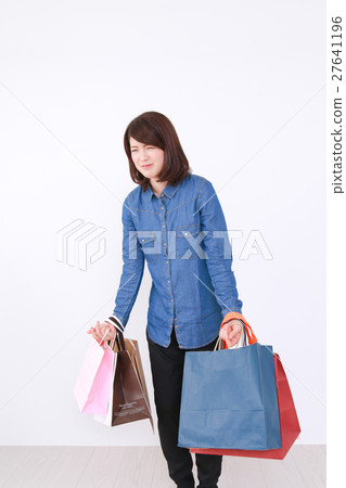A woman with a shopping bag A woman with a shopping bag 27641196