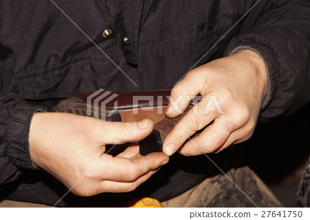 Shoemaker is repairing leather shoe.Hands closeup. 27641750