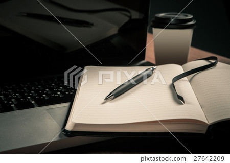 Notebook lying on the laptop. 27642209