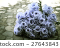 bouquet of blue rose lying on grey road 27643843