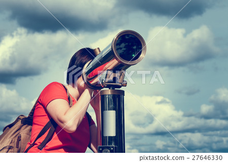 Woman looking through tourist telescope, Woman looking through tourist telescope, 27646330