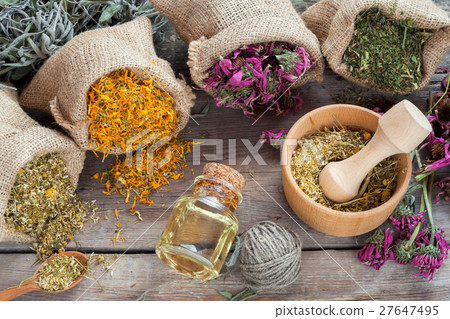 Healing herbs, wooden mortar of chamomile 27647495