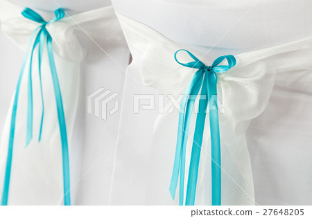 Wedding chairs with blue ribbons. 27648205