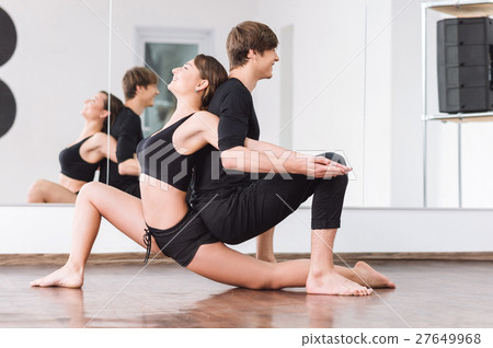 Joyful positive dancers sitting backtoback Joyful positive dancers sitting backtoback 27649968